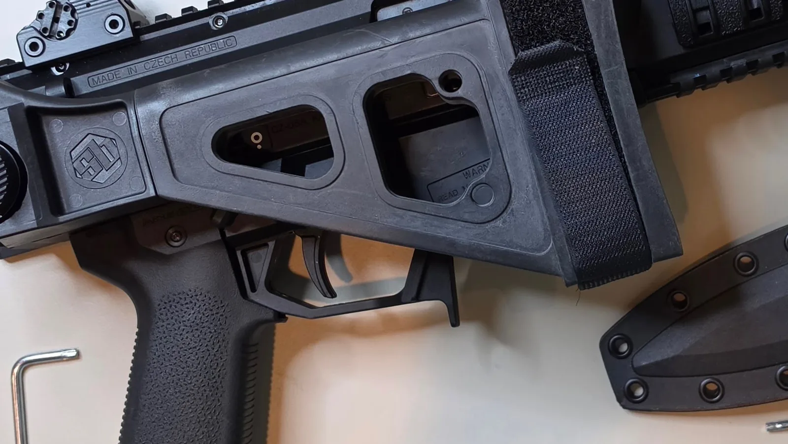 SB Tactical folding brace closed along the right side of a CZ Scorpion EVO 3 receiver, above a Magpul MOE-EVO grip and an extended magazine release