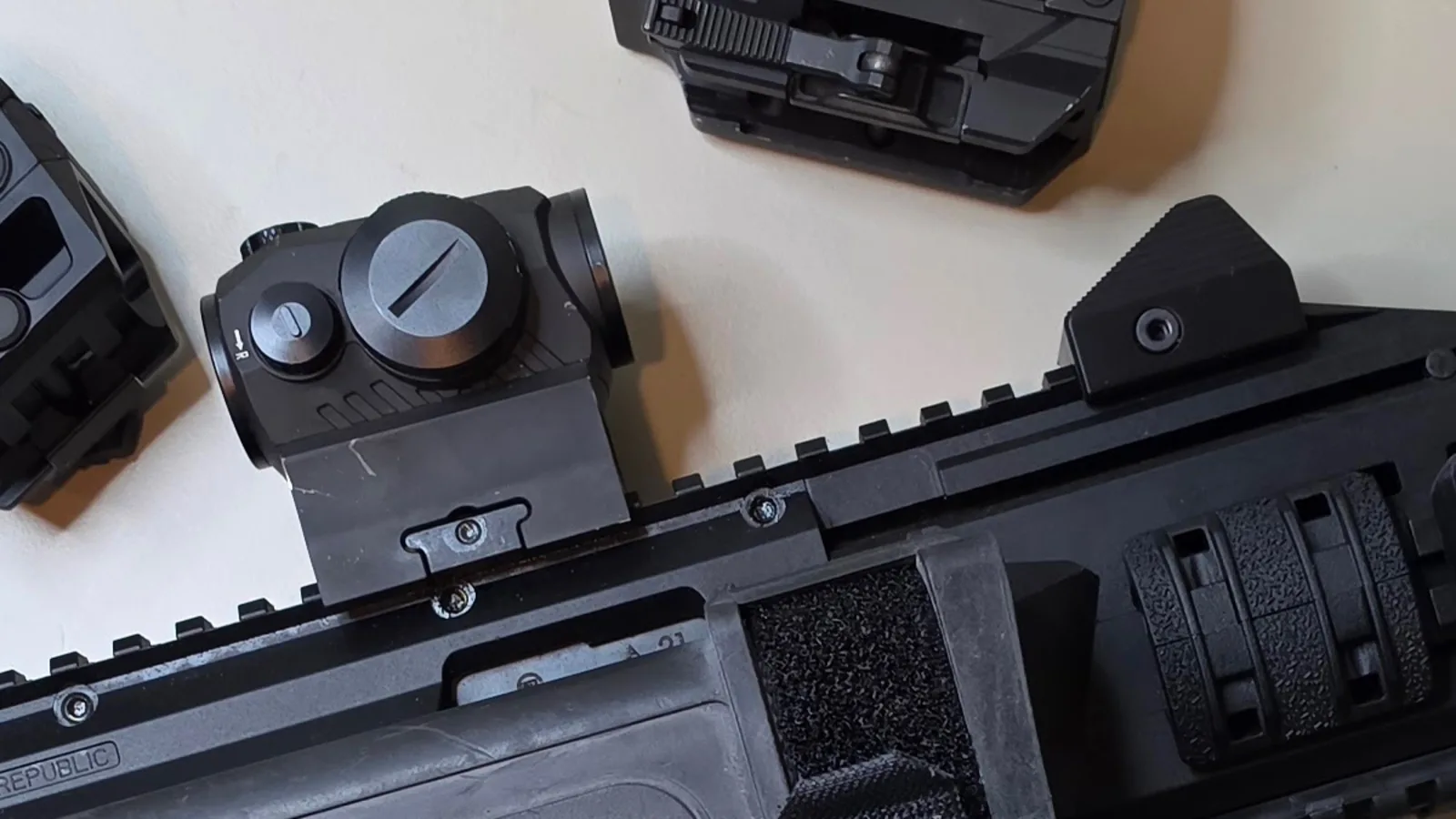 Sig Sauer Romeo5 red dot on a riser mount, clamped to the top rail of a CZ Scorpion EVO 3 ahead of a folded backup sight