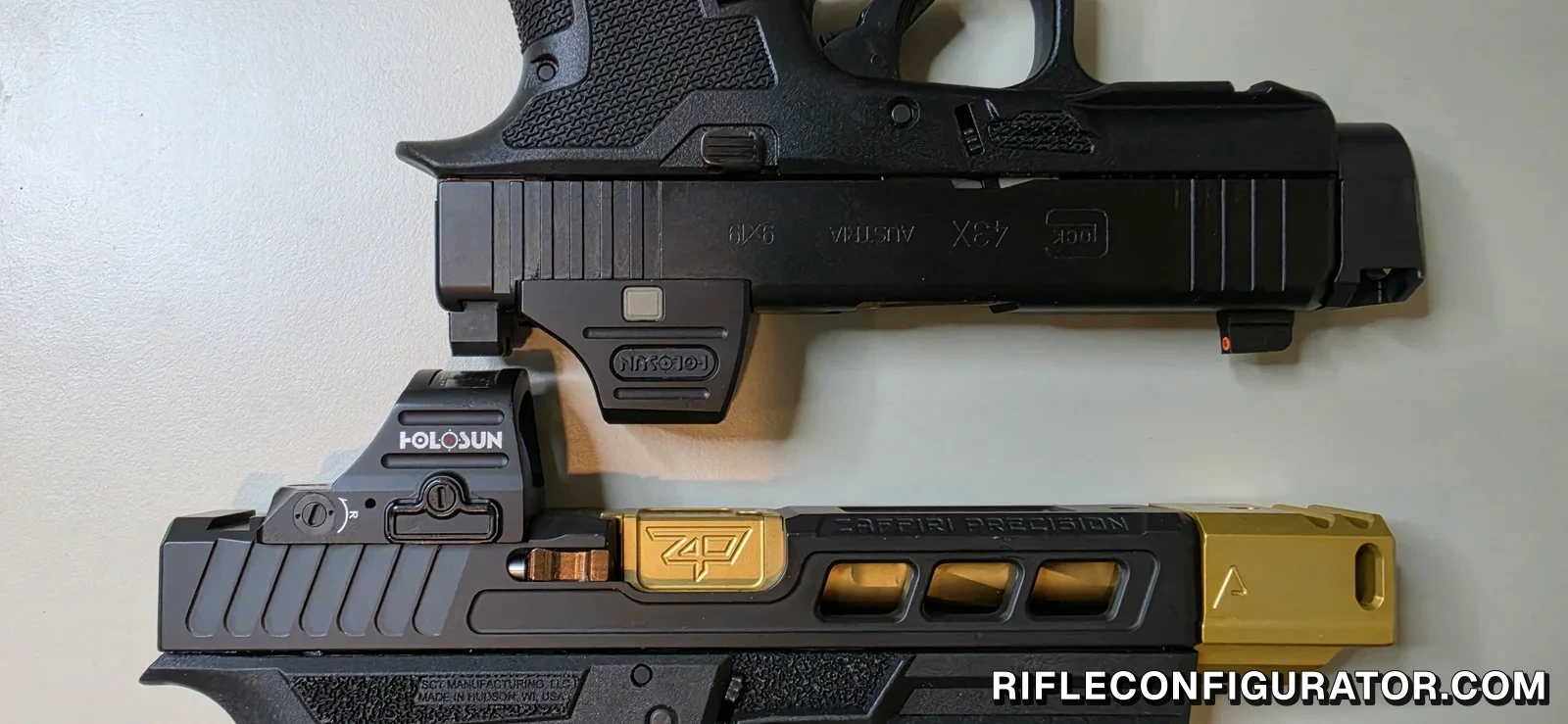 Two comped Glock-pattern pistols laid parallel, a slimline slide with a black compensator at the muzzle above a full-size ported slide with a gold compensator and a Holosun red dot